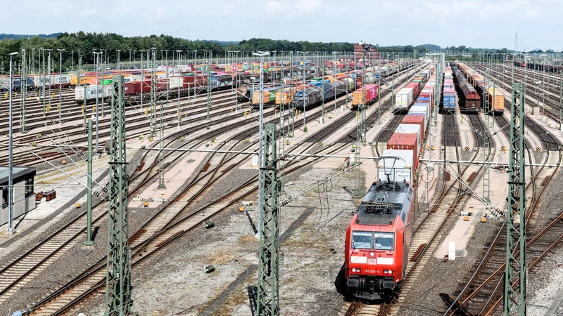 Containers, trains, and trucks moving freight through an intermodal terminal
