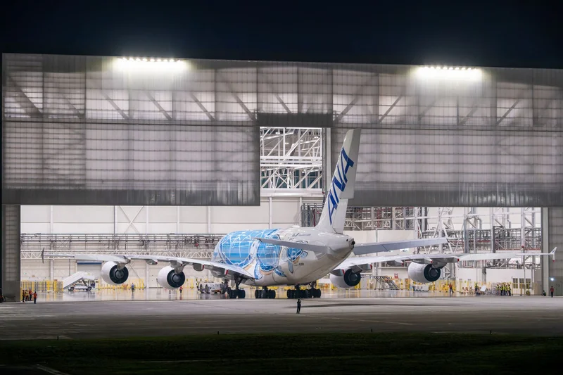 Wide-body passenger aircraft inside an aviation maintenance hangar