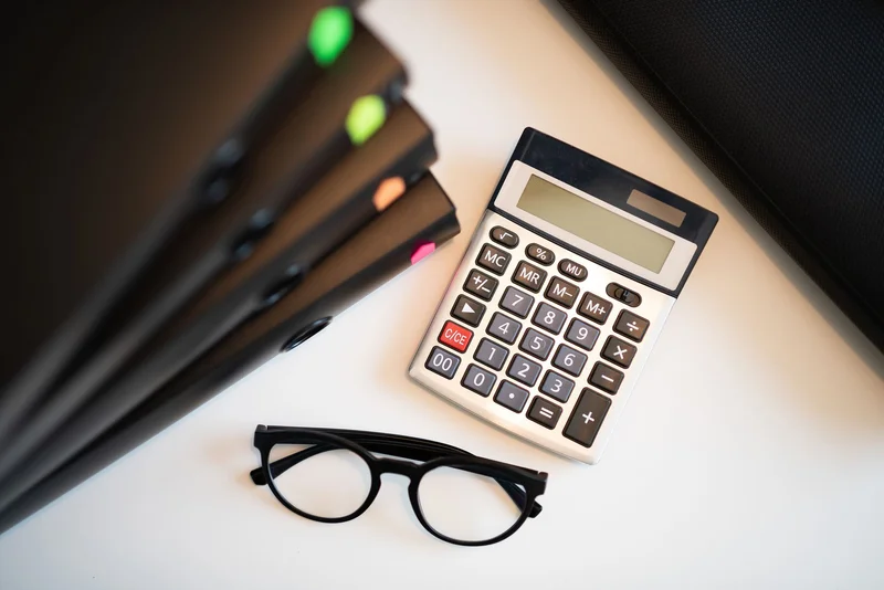 Education loan documents beside a calculator during a refinancing review