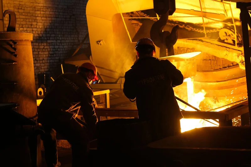 Maintenance work taking place around heavy steelmaking equipment