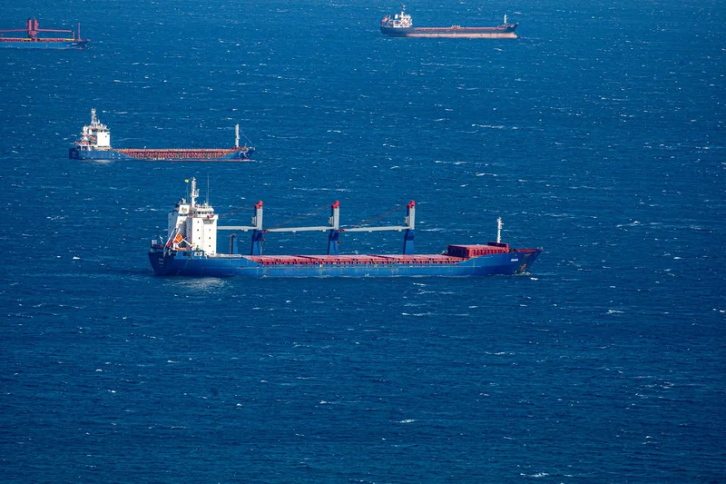 Commercial vessels crossing open water as shipping continues through the Strait of Hormuz